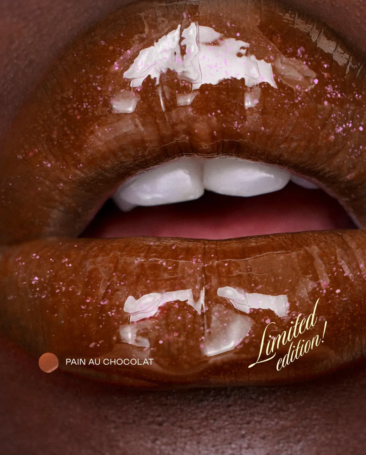 Close-up of deep-toned lips in glossy warm brown Pain au Chocolat balm flecked with pink shimmer
