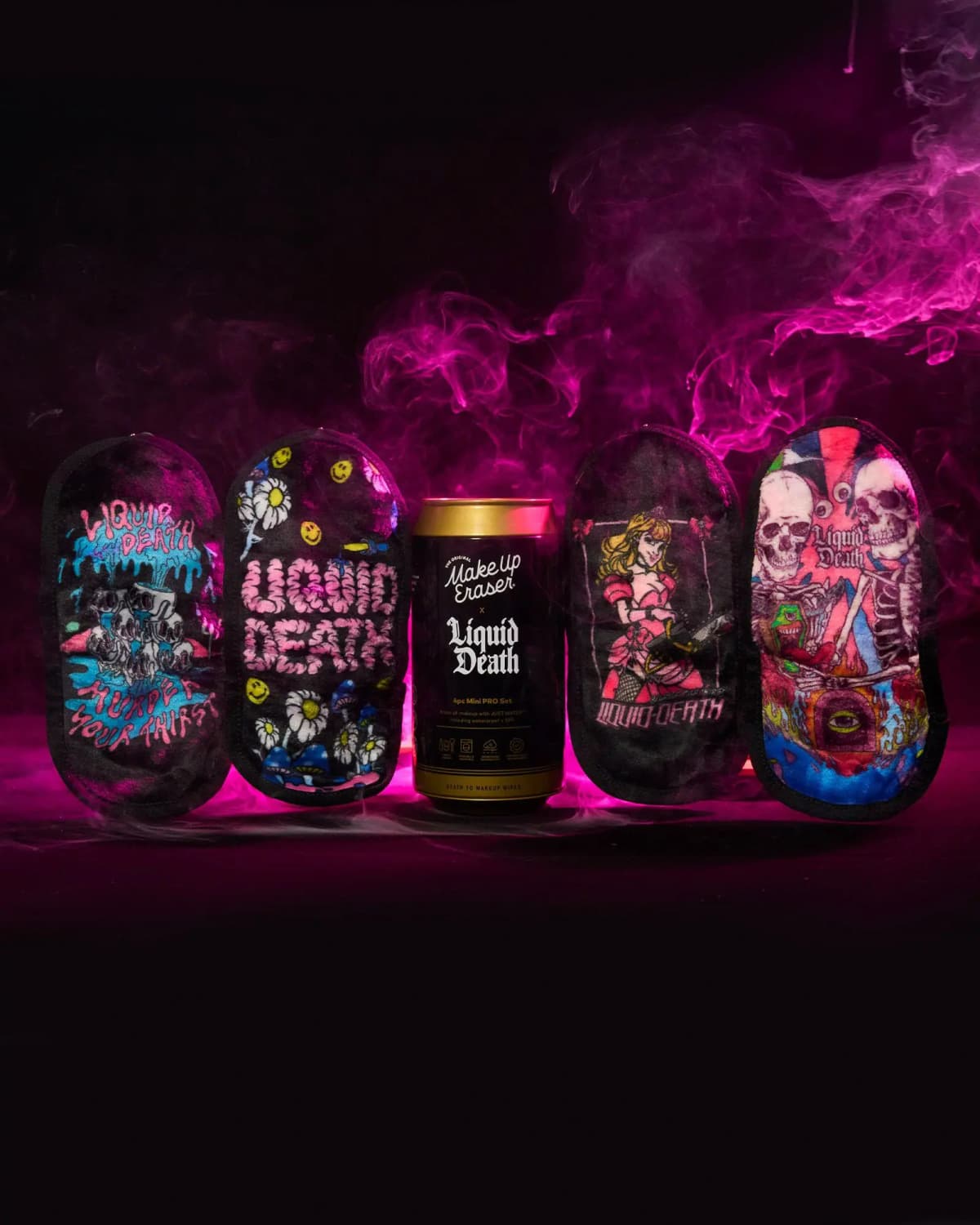 Four printed Liquid Death erasers lined up beside the gold-topped can amid swirling pink smoke