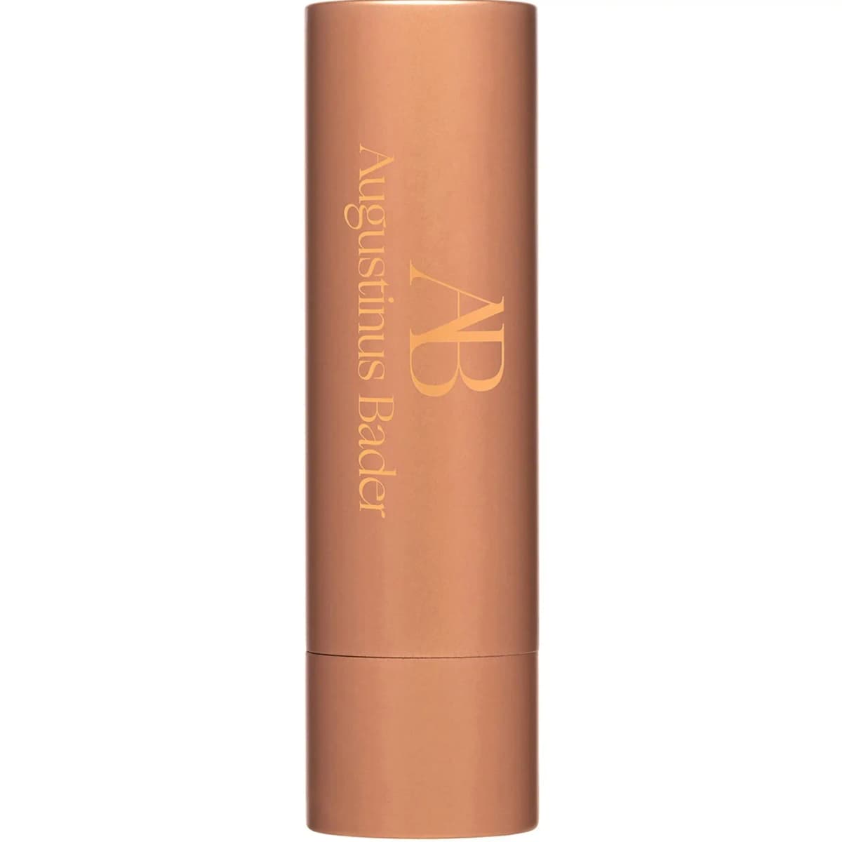 Augustinus Bader lip balm in a matte rose-gold tube with engraved AB logo