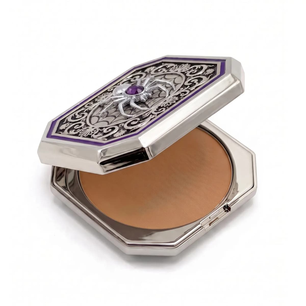 Spider compact with lid raised above a warm tan pressed powder in a polished silver octagonal base