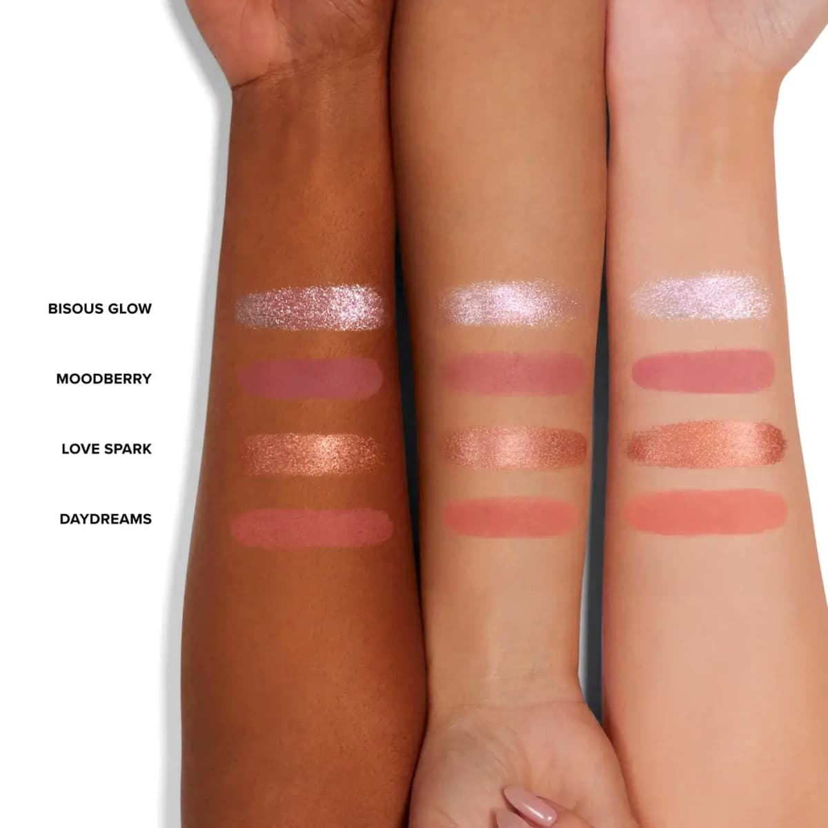 Three arms of different skin tones showing swatches of Bisous Glow, Moodberry, Love Spark and Daydreams.