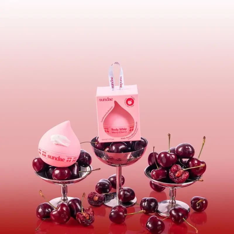Pink Merry Cherry Body Whip jar and box set in silver coupes filled with dark cherries