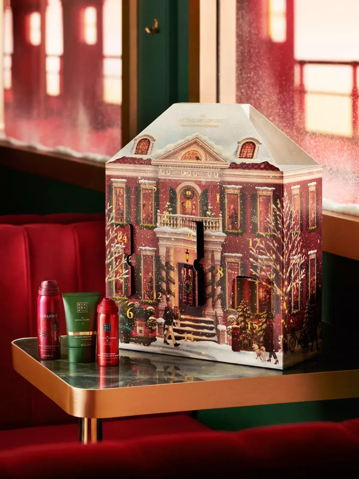 Townhouse calendar with doors open on a marble table beside Uukumwe, Ritual of Jing and Ritual of Ayurveda minis