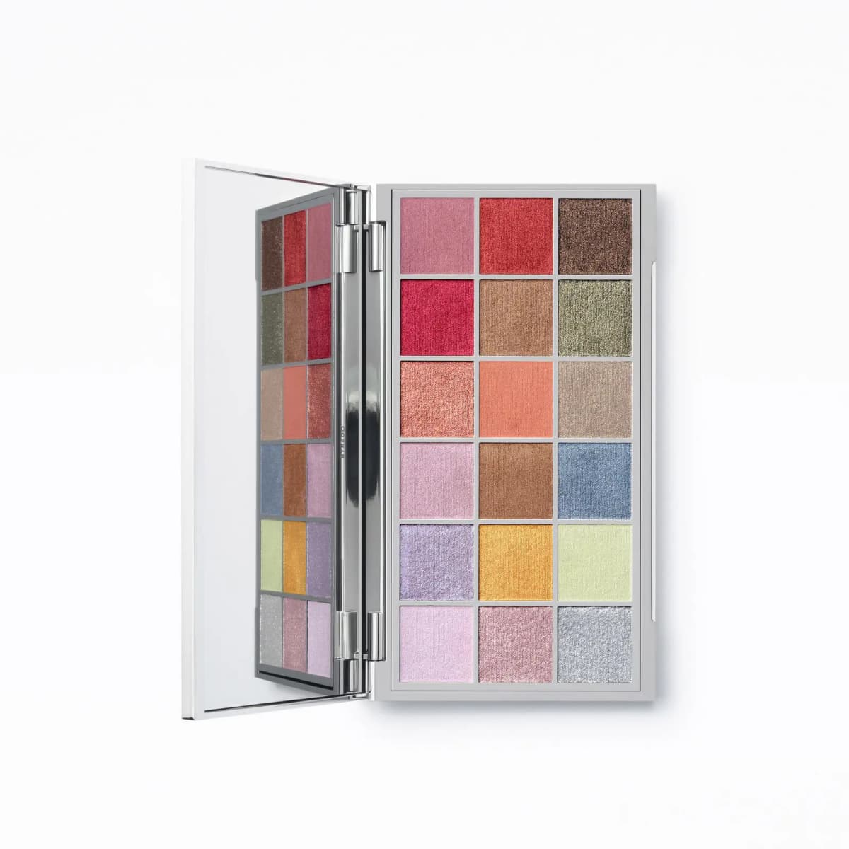 Palette opened flat from above, 18 shades in six rows reflected in the mirror on the hinged silver lid