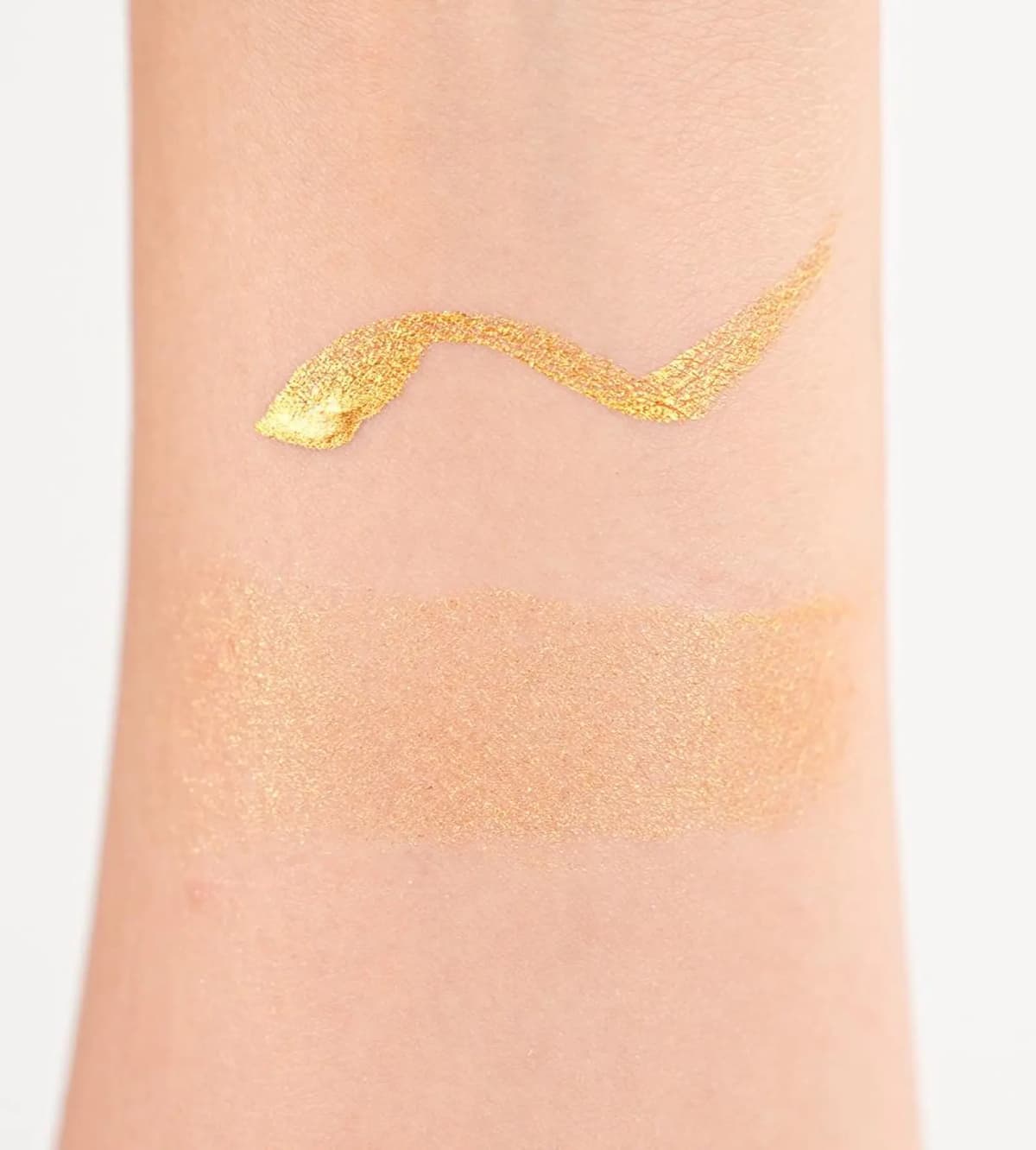 Arm swatch of the Chanel Holiday 2026 metallic gold liquid eyeliner