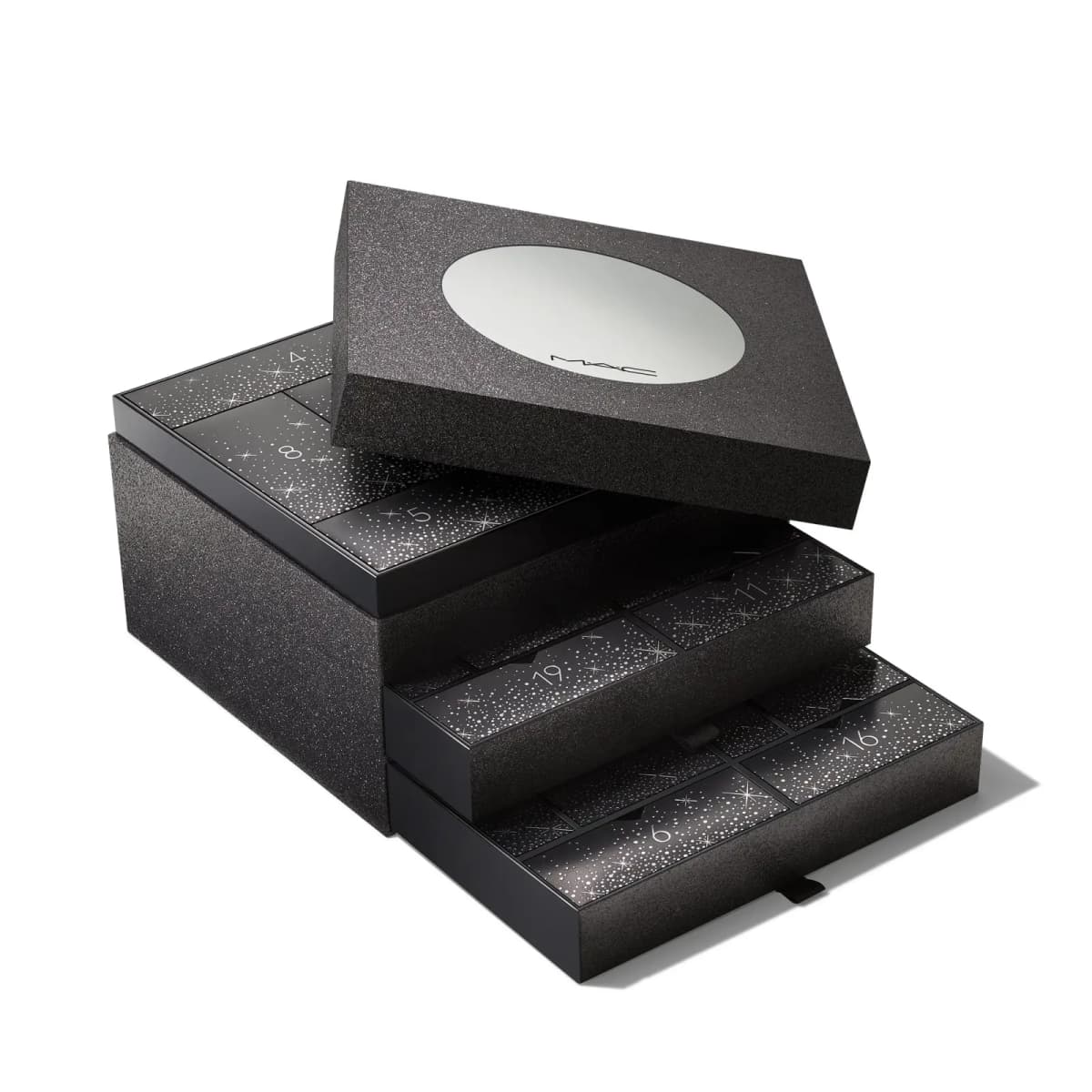 Black glitter M·A·C advent calendar with pull-out drawers of numbered starry doors and a lid with a round mirror.