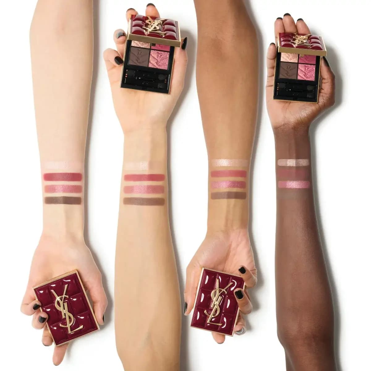 Four forearms of different skin tones with eyeshadow swatches, hands holding the burgundy quilted palette