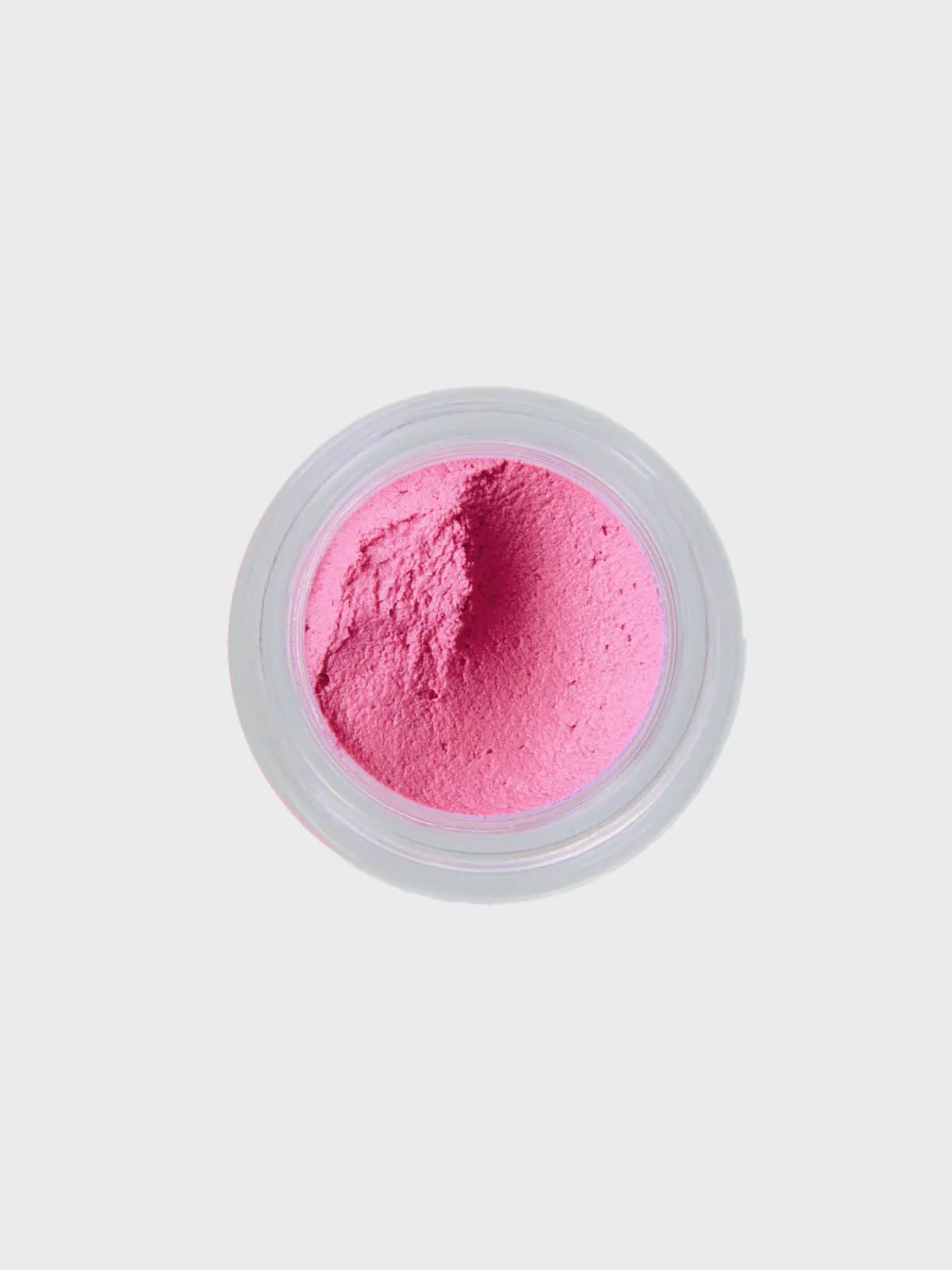 Top-down view of open Rose Bonbon mousse blush, a whipped pink texture in a clear jar