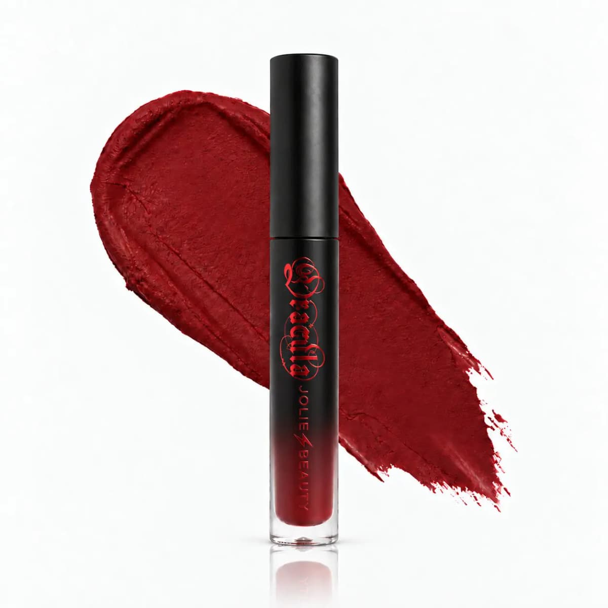 Black-to-red ombré lip tube in front of a thick, creamy deep red swatch on white