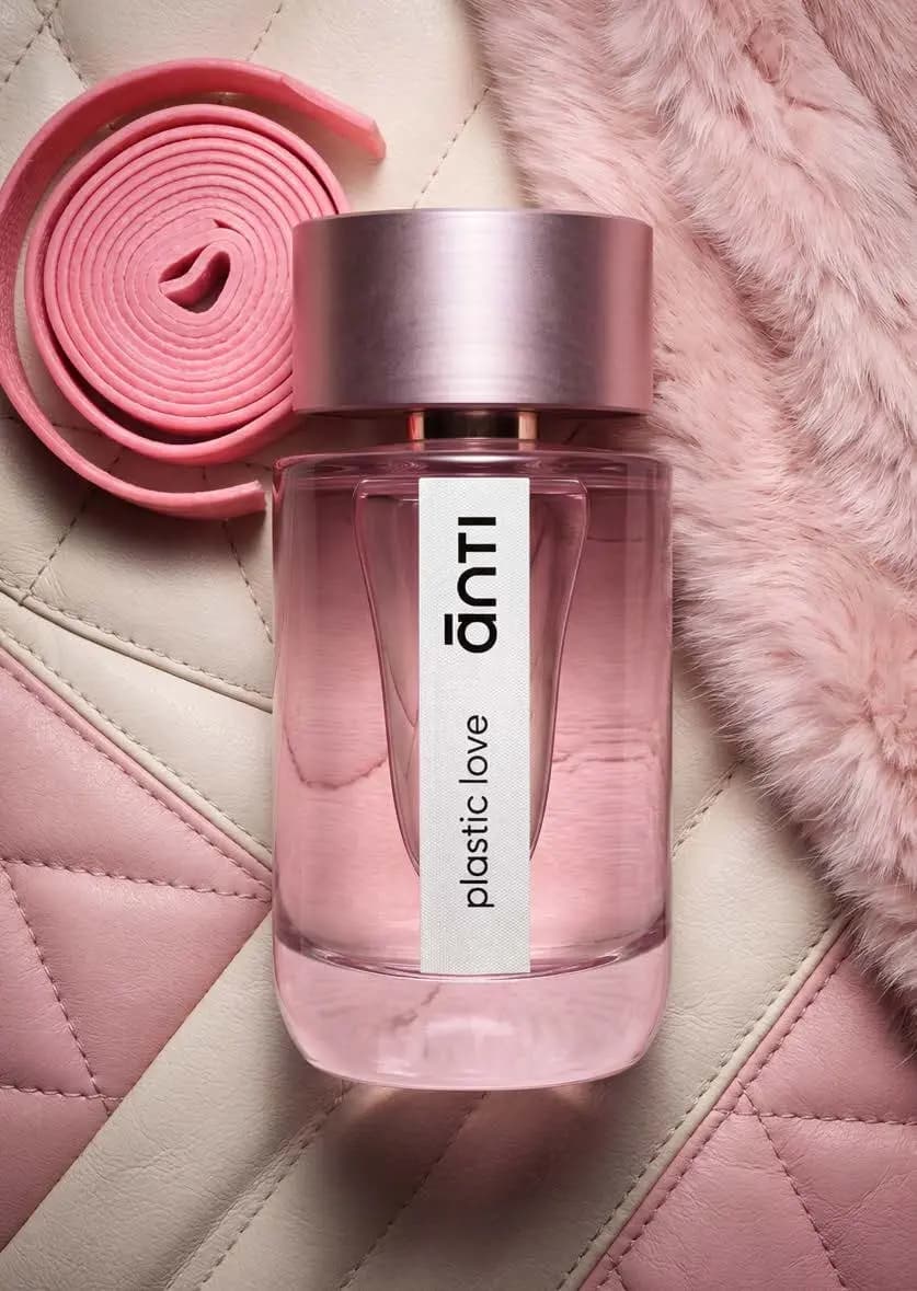 Ānti Plastic Love Eau de Parfum bottle, pink glass and rose metal cap, on quilted leather with pink fur and a coiled strap