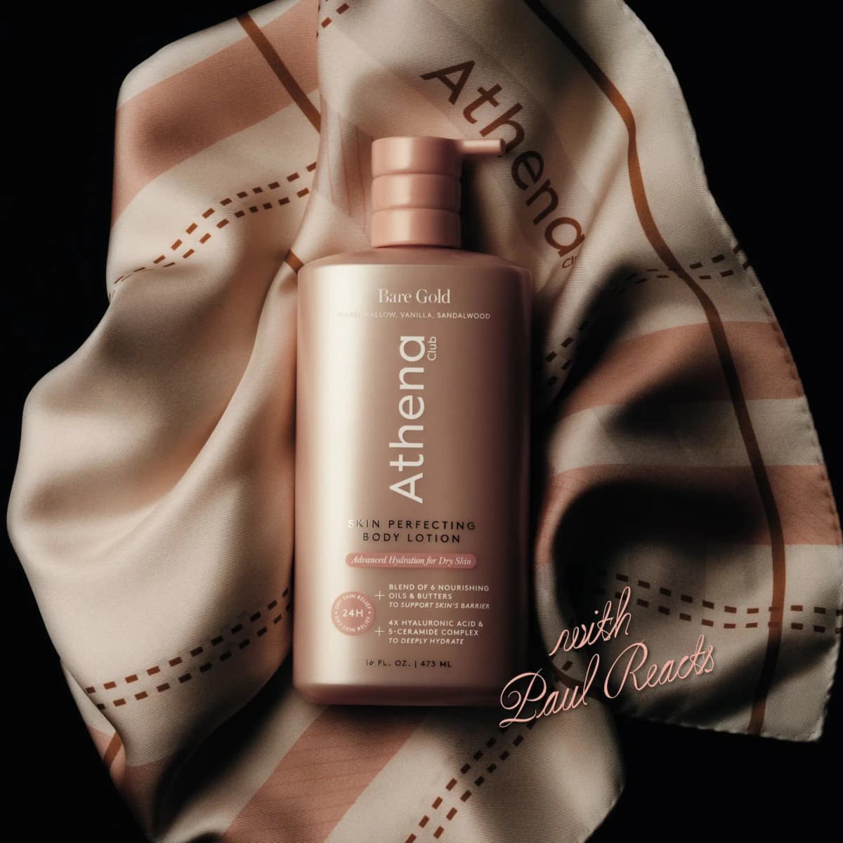 Rose-gold pump lotion bottle resting on a draped silk scarf printed with Athena and dashed stripes