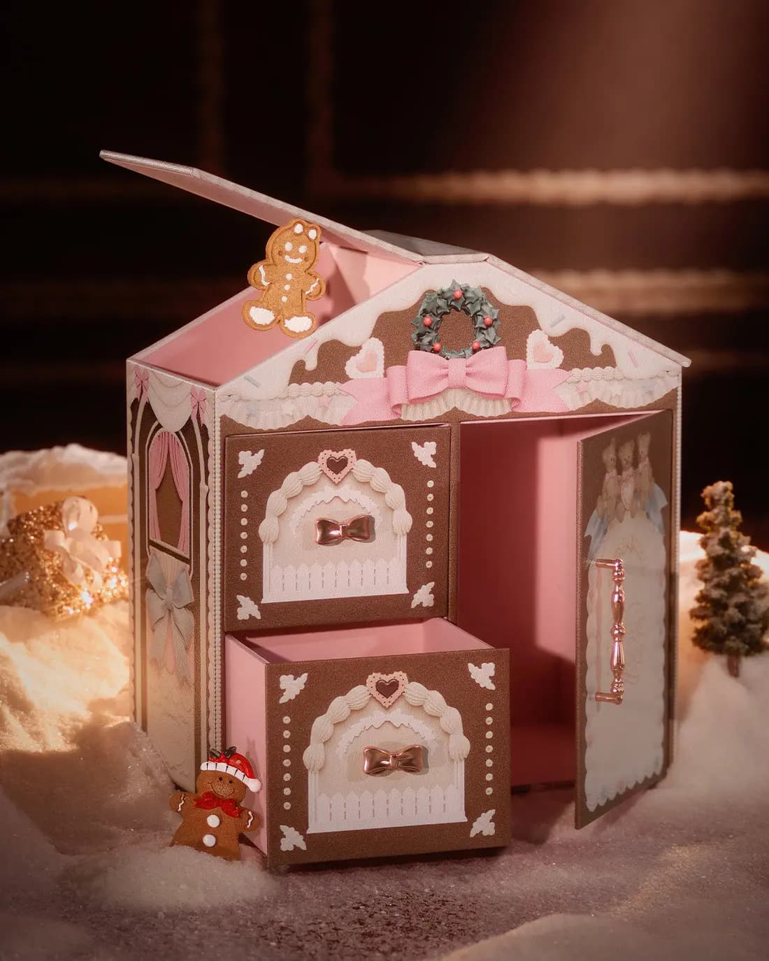 House-shaped box with roof lifted, door open and lower drawer pulled out, revealing a pink interior