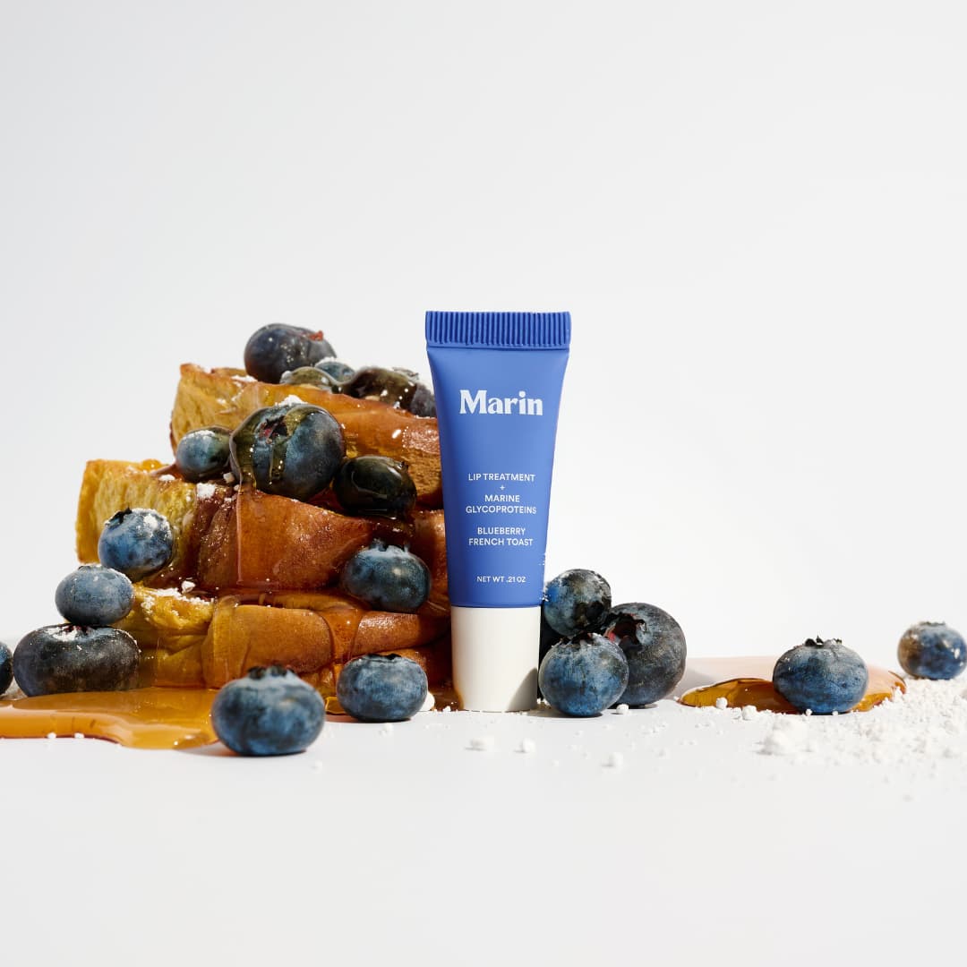 Blue Blueberry French Toast tube beside syrupy French toast, blueberries and powdered sugar