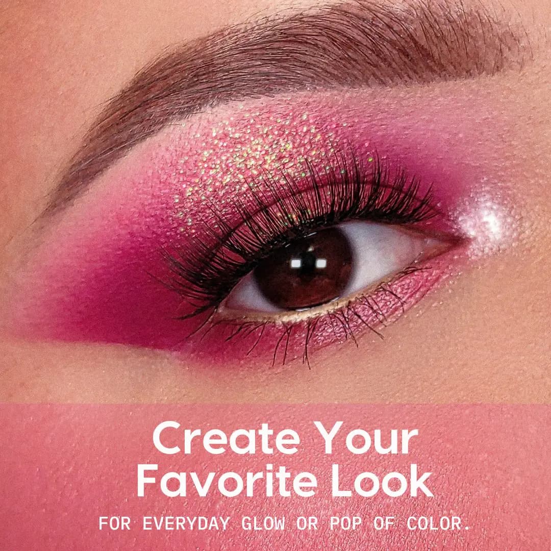 Close-up eye with magenta matte shadow, green-gold glitter on the lid and a pink inner-corner highlight