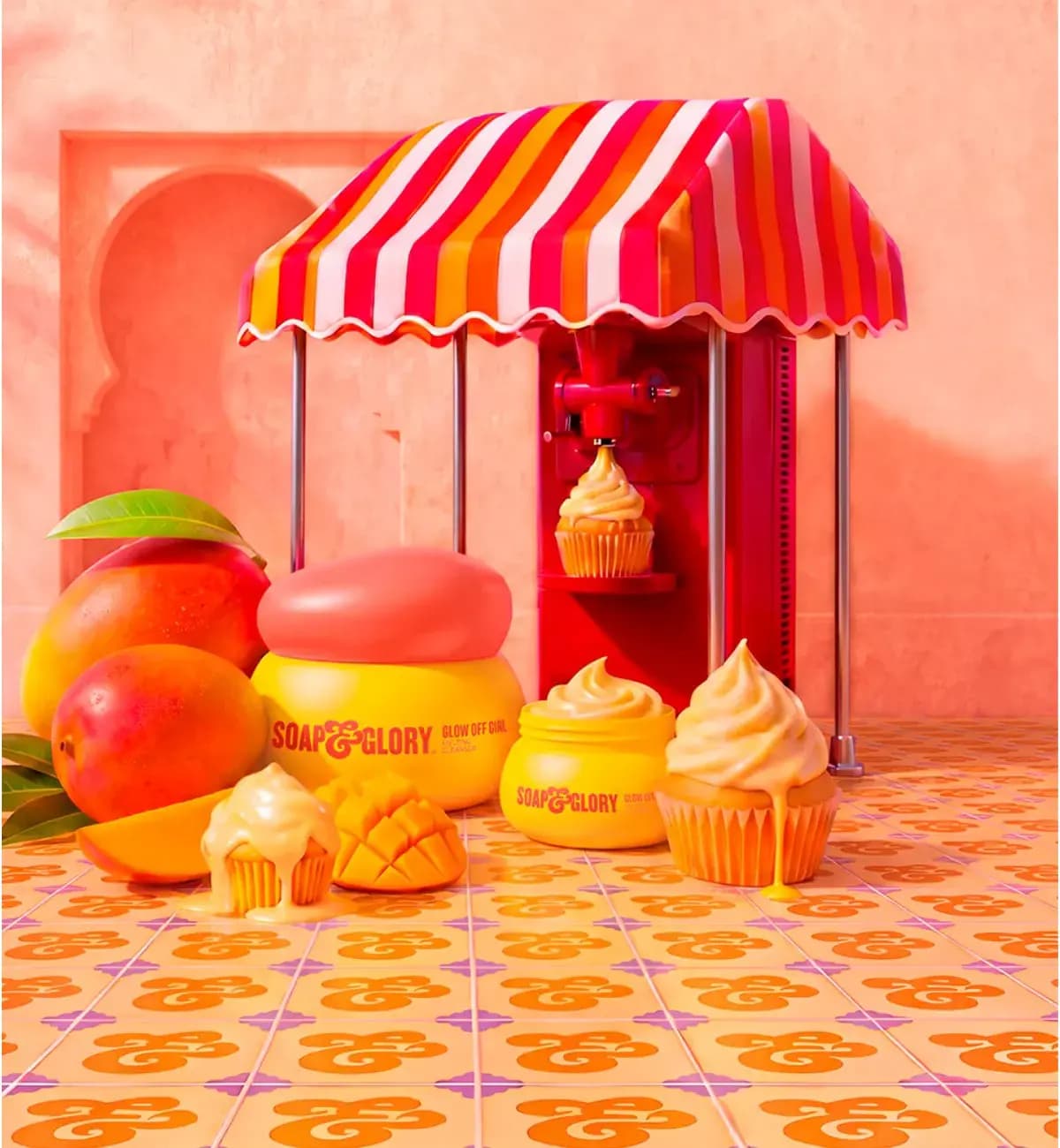 Yellow Glow Off Girl Melting Cleanser jars with coral lid beside mangoes and cupcakes under a striped awning
