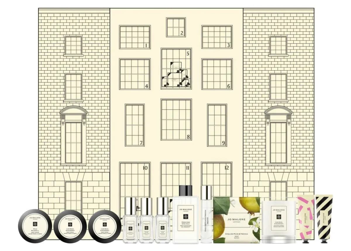Jo Malone London advent calendar with numbered townhouse windows 1–12, with body crèmes, colognes, soap and candle in front