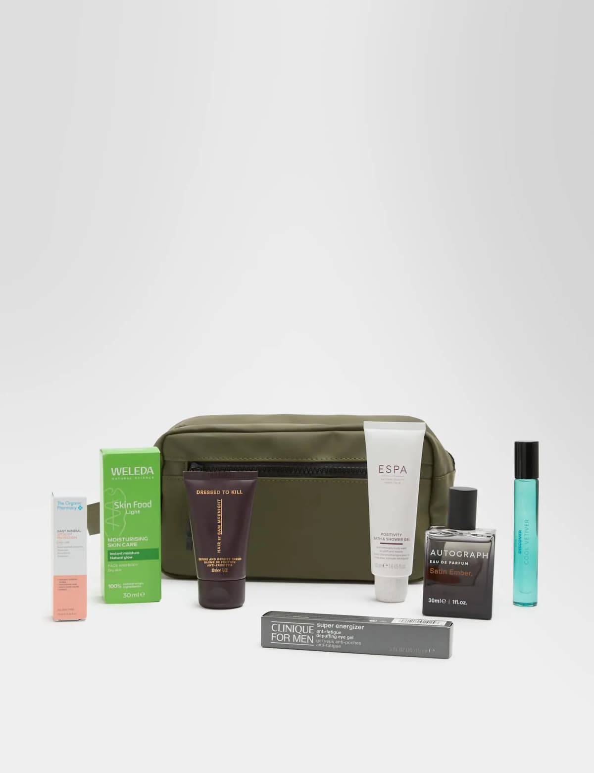 Seven grooming products including Weleda Skin Food Light and ESPA gel laid out in front of an olive zip wash bag on grey