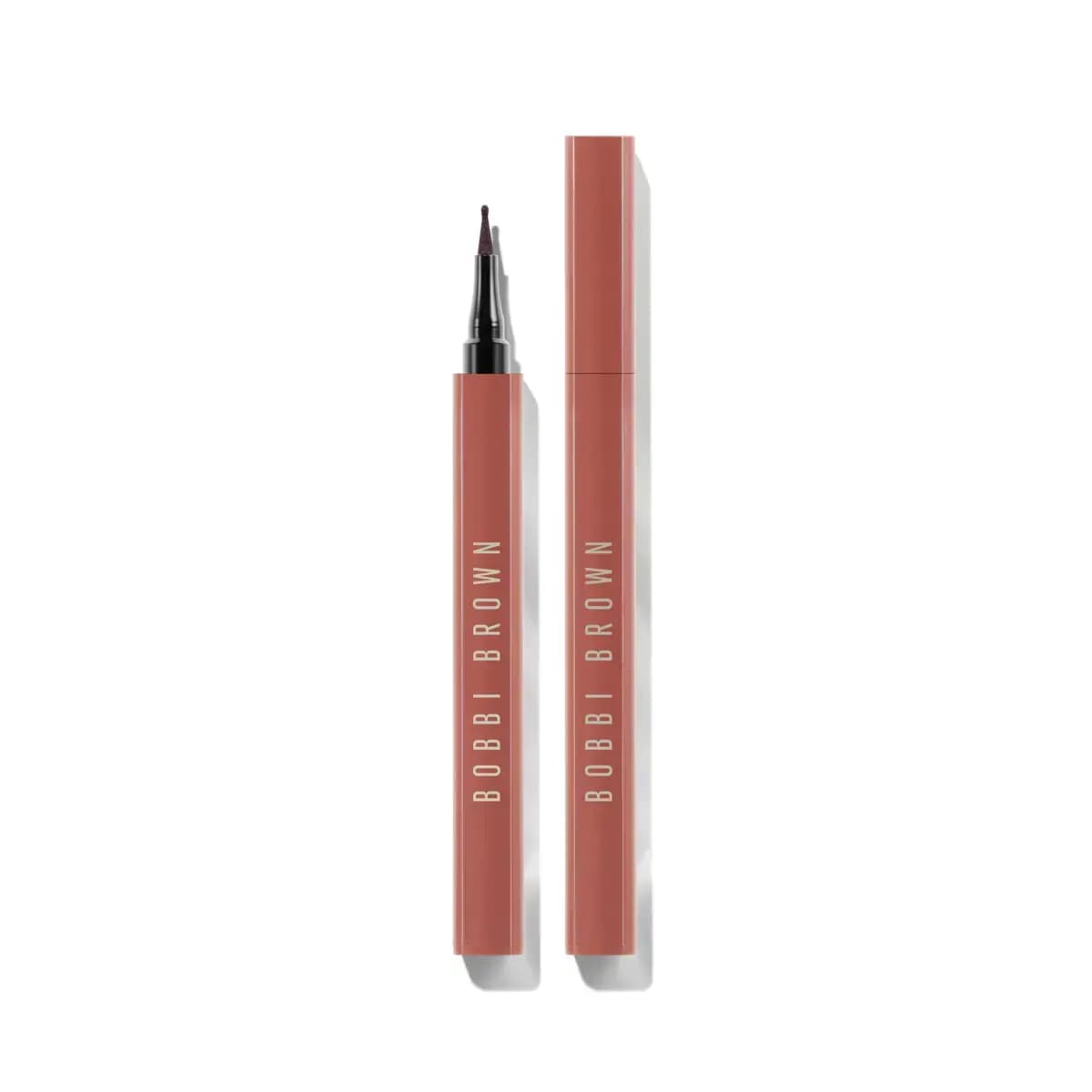 Bobbi Brown Lip Tint Liner with a fine felt tip in a terracotta-pink tube, shown uncapped beside its capped twin.
