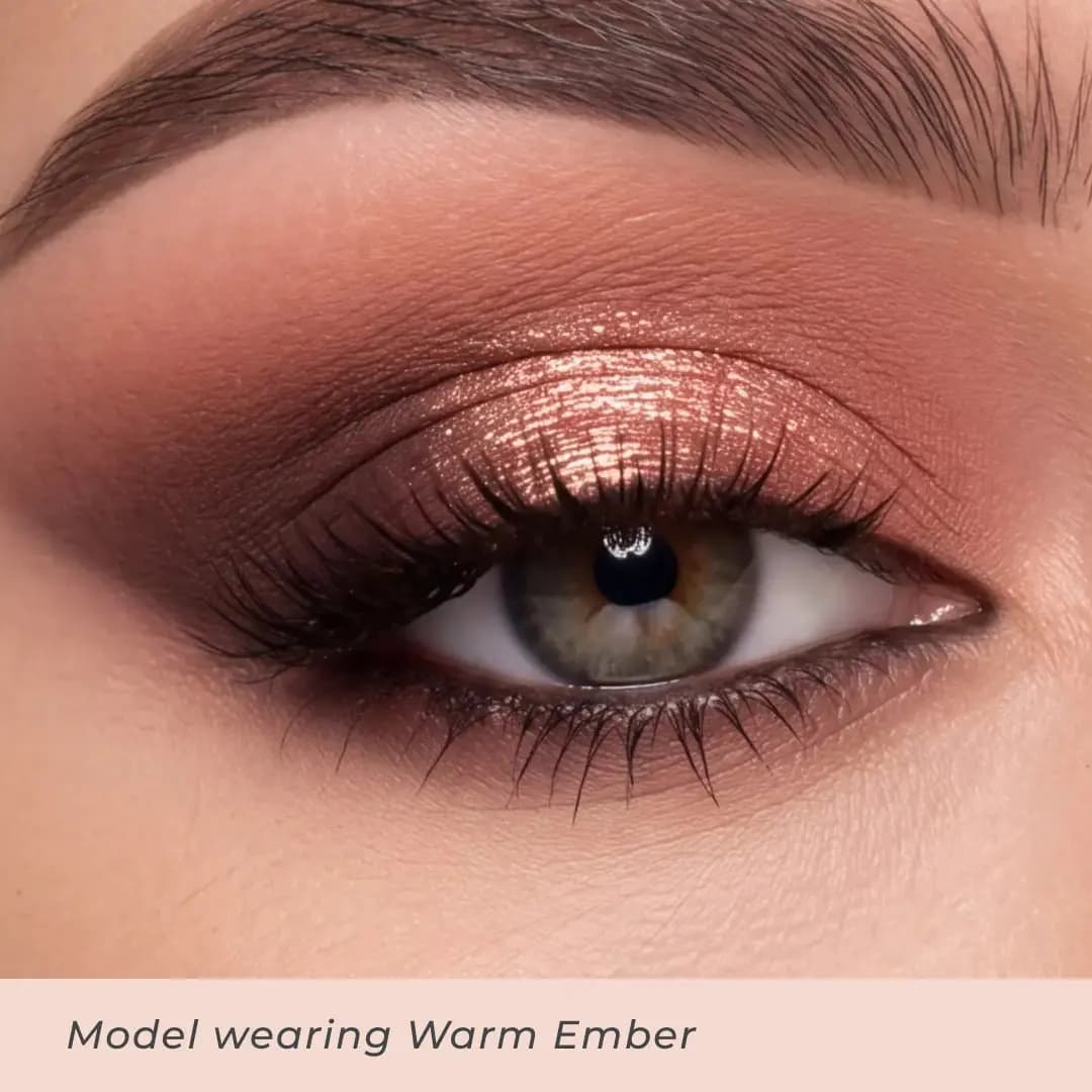 Close-up eye wearing Warm Ember with a copper metallic lid, rosy crease and dark brown smoked outer corner