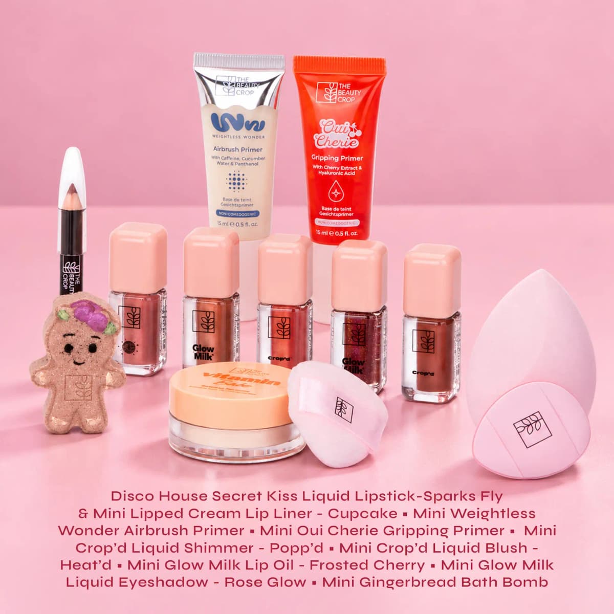 Mini Weightless Wonder and Oui Cherie primers, Glow Milk and Crop'd liquid minis, gingerbread bath bomb and pink sponge.