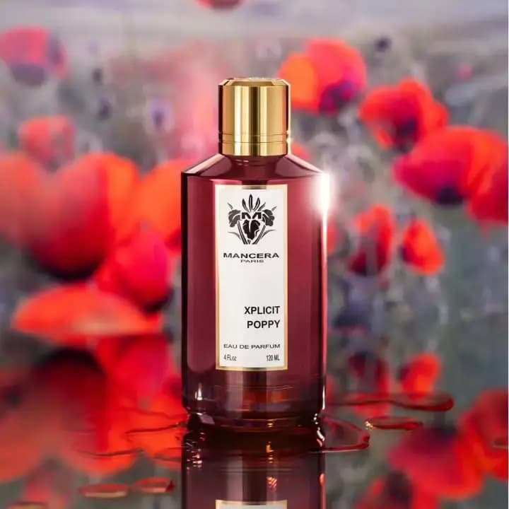 Xplicit Poppy Eau de Parfum 120 ml bottle in deep red glass among blurred red poppies, reflected in water