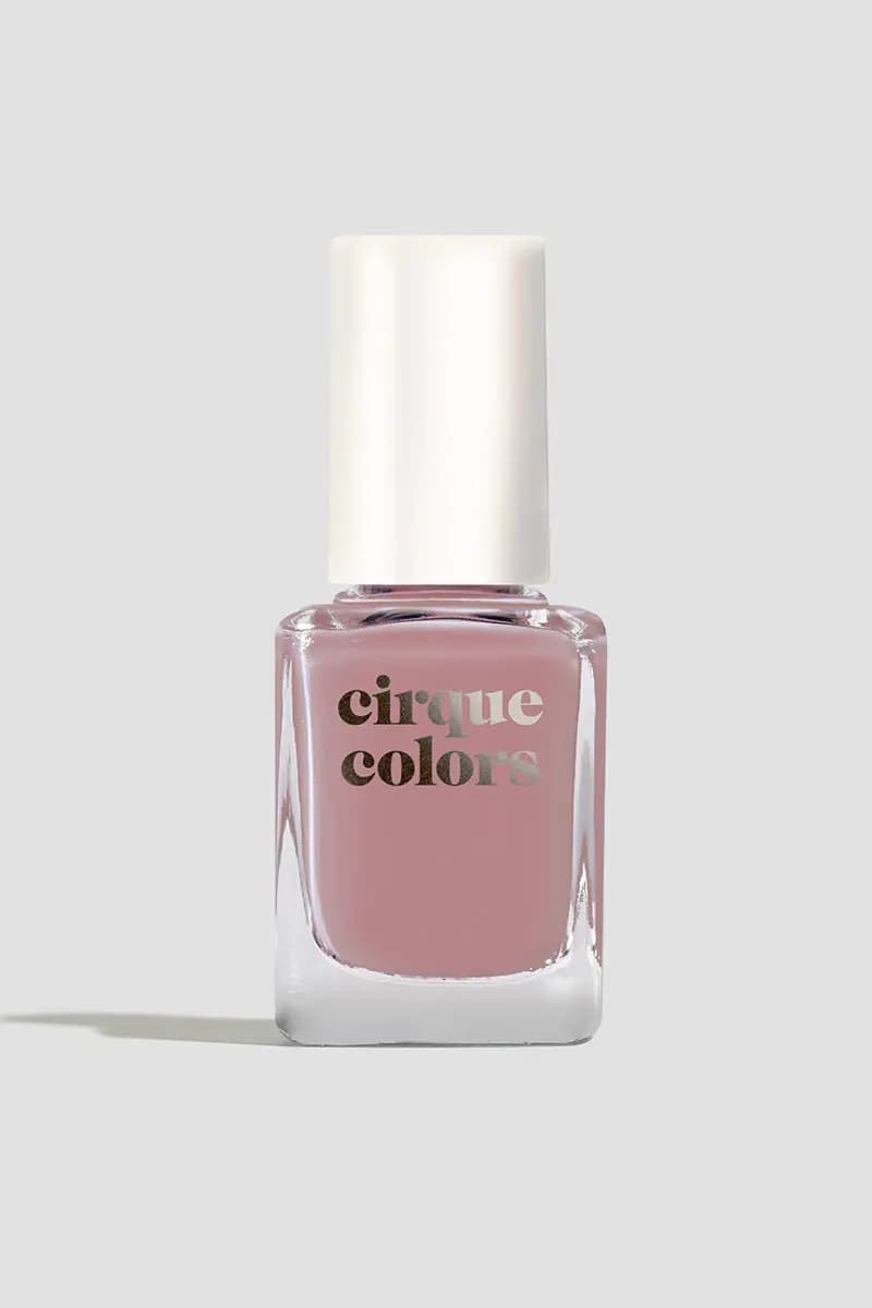Single bottle of dusty rose crelly polish with a white cap on a pale grey background