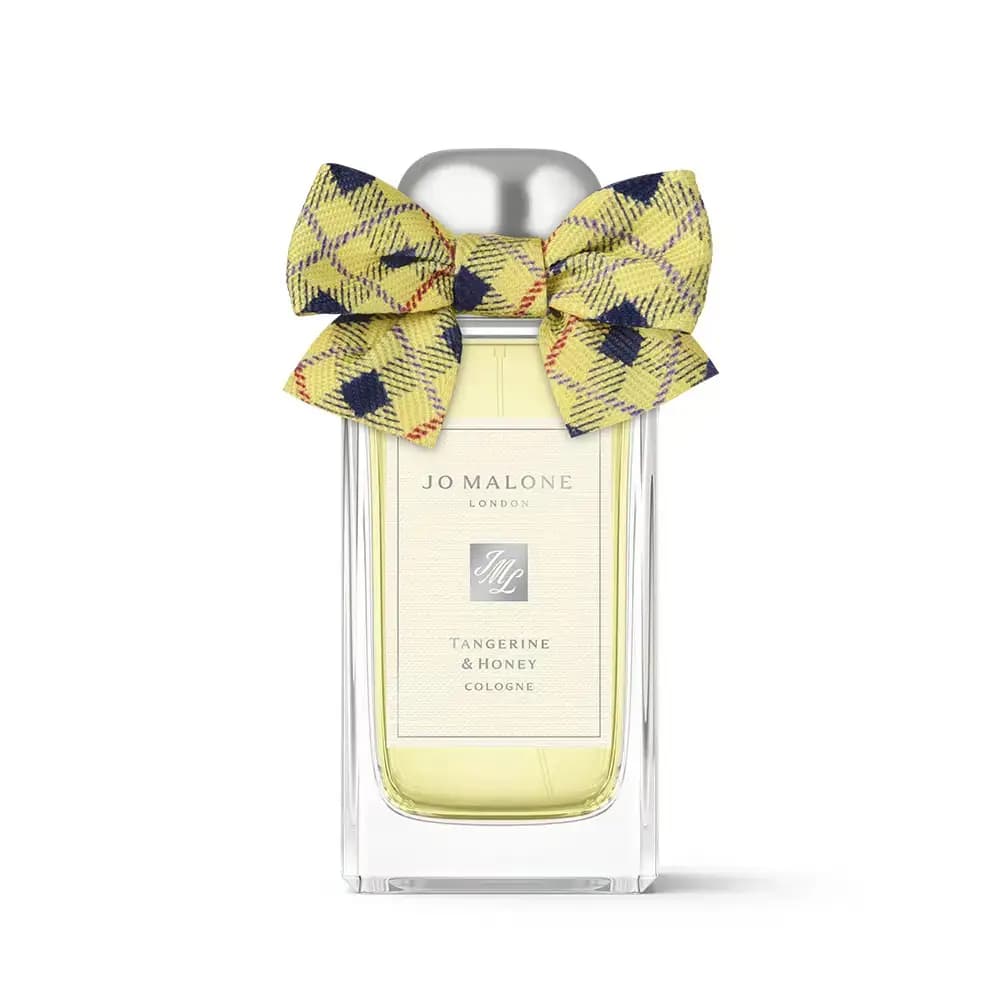 Jo Malone London Tangerine & Honey Cologne bottle with pale yellow juice, silver cap and yellow-navy tartan bow on white