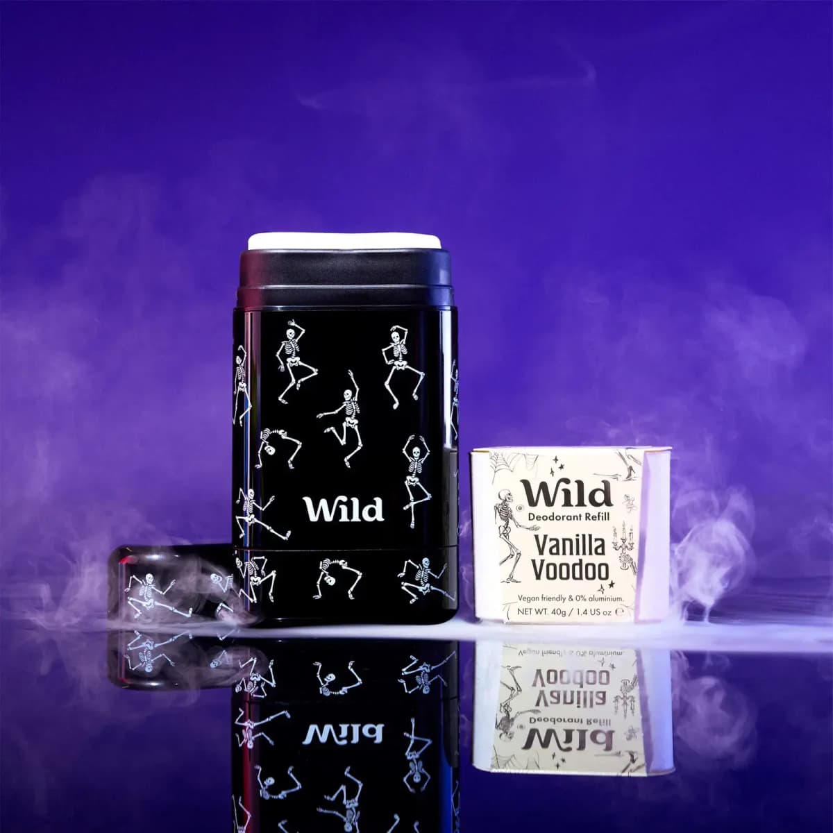 Black Wild Dancing Skeletons stick deodorant case beside a cream Vanilla Voodoo refill box amid purple fog
