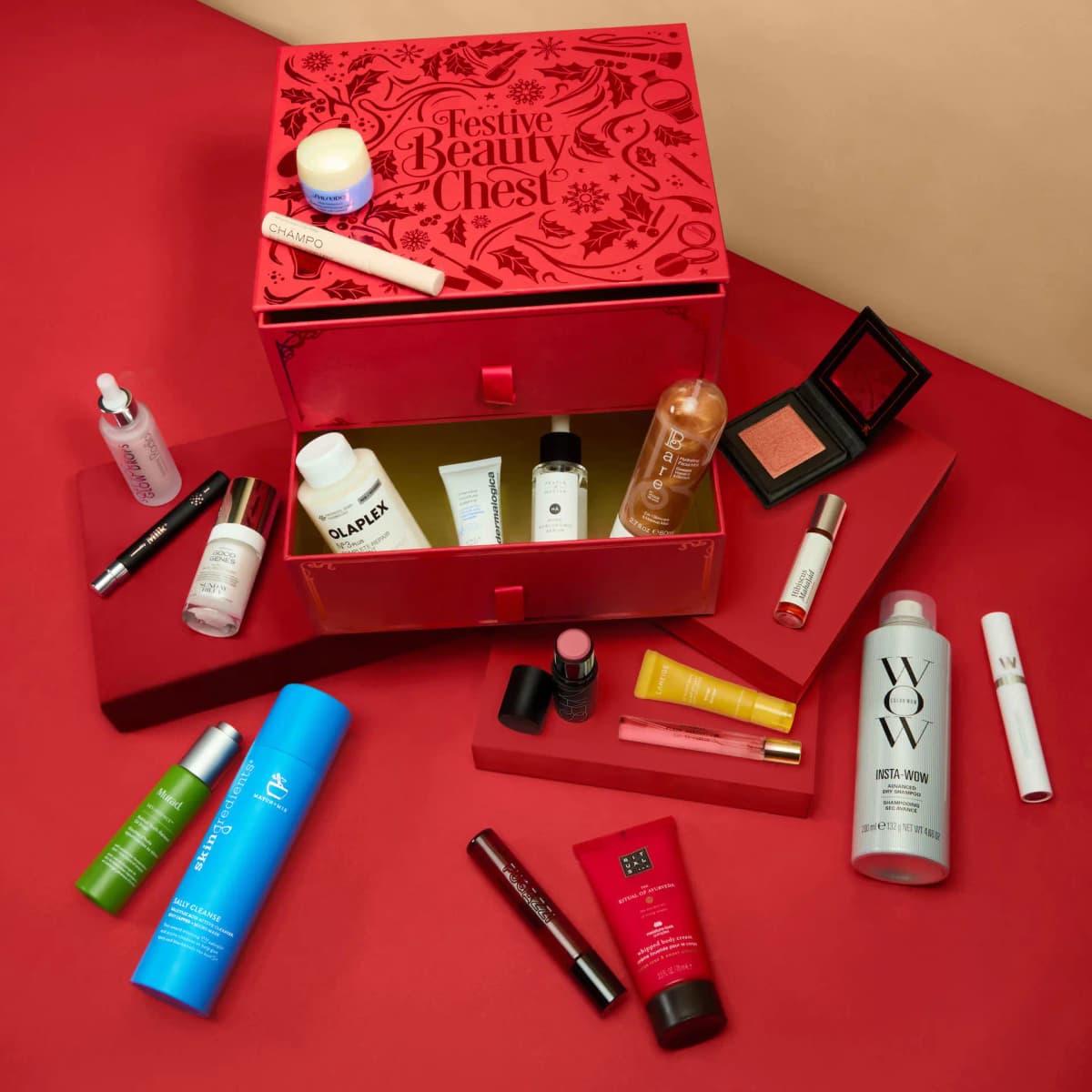 Overhead view of the open chest with Olaplex, Dermalogica and Bare in the drawer, blush compact and products around it
