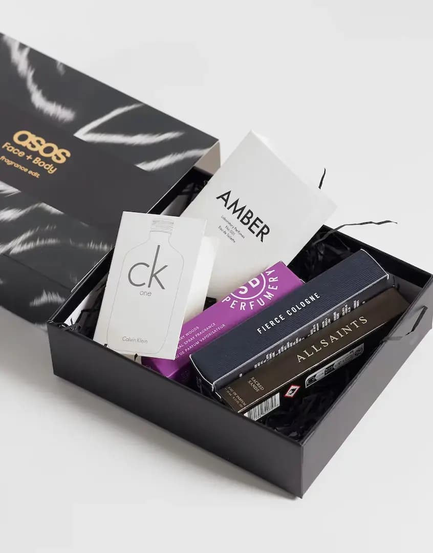 Open black box with CK One and Amber sample cards, purple SB Perfumery box, Fierce Cologne and AllSaints cartons