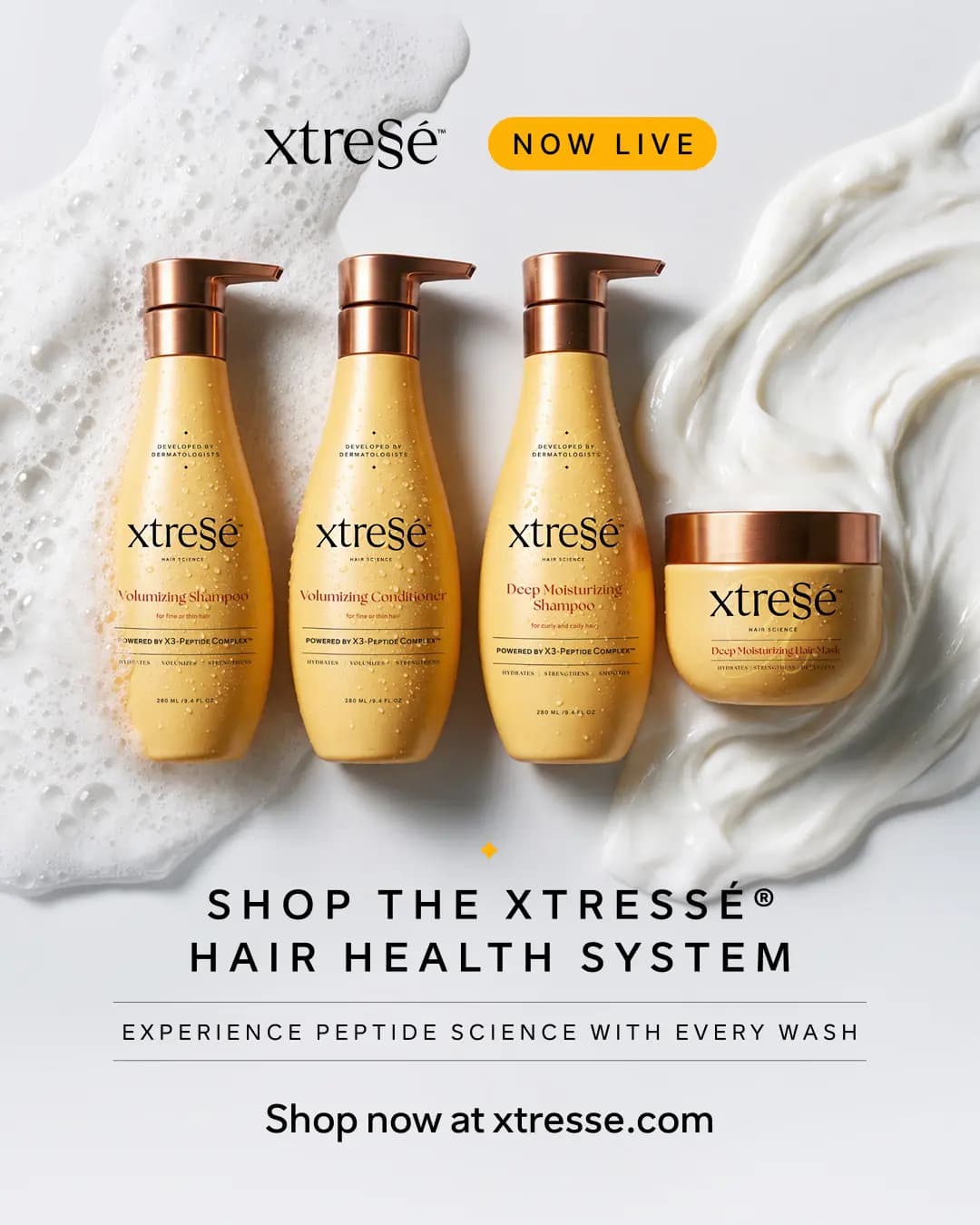 Xtressé Peptide Shampoo & Conditioner systems: four yellow bottles and a jar with copper caps beside foam and cream swirls