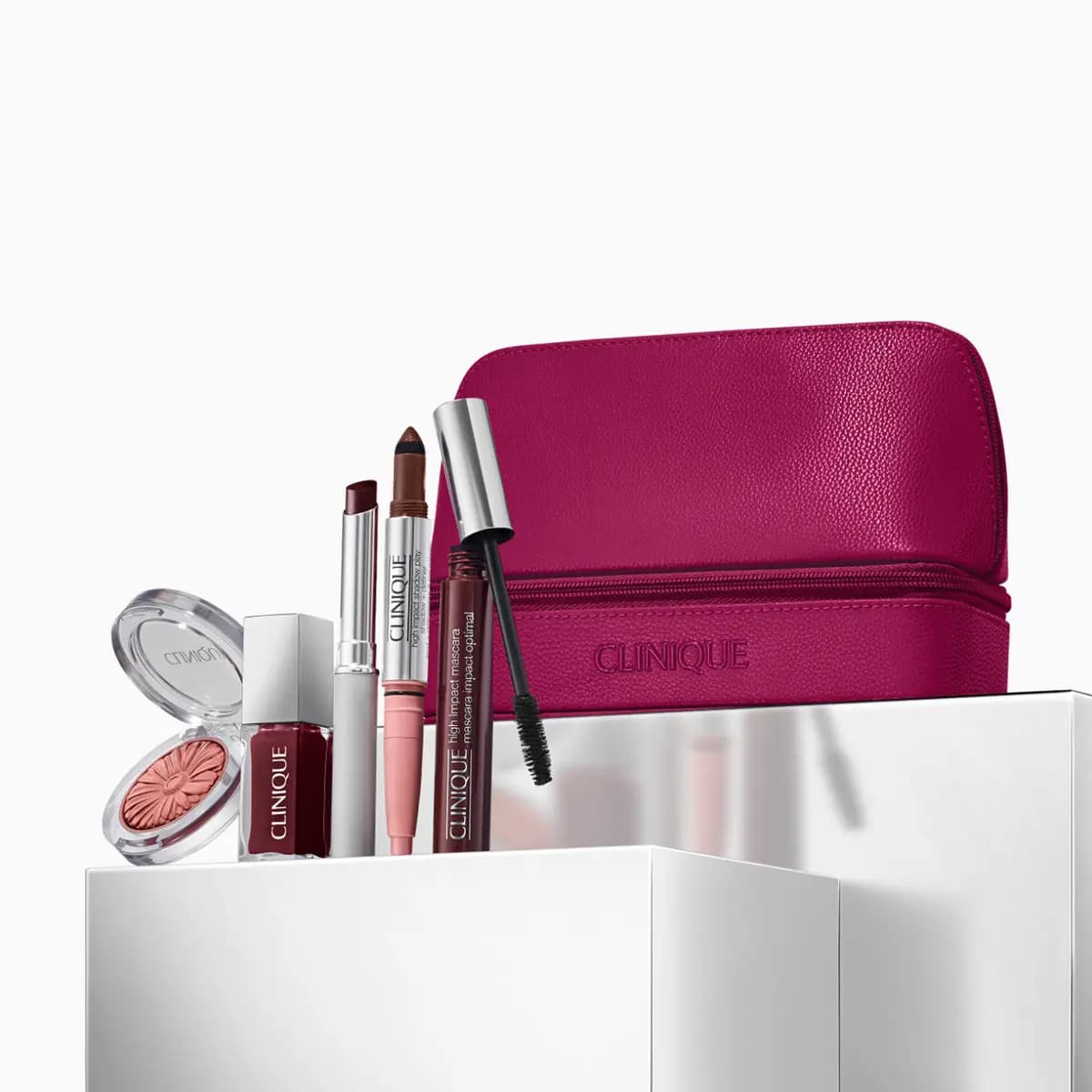 Magenta pouch with daisy-embossed blush, lip gloss, lipstick, High Impact Shadow Play stick and High Impact Mascara