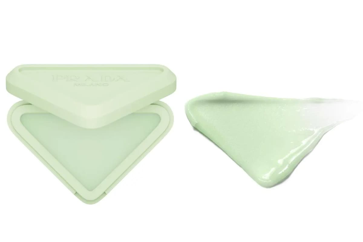 Open mint-green Prada compact with pale green lip balm beside a smooth, glossy green swatch
