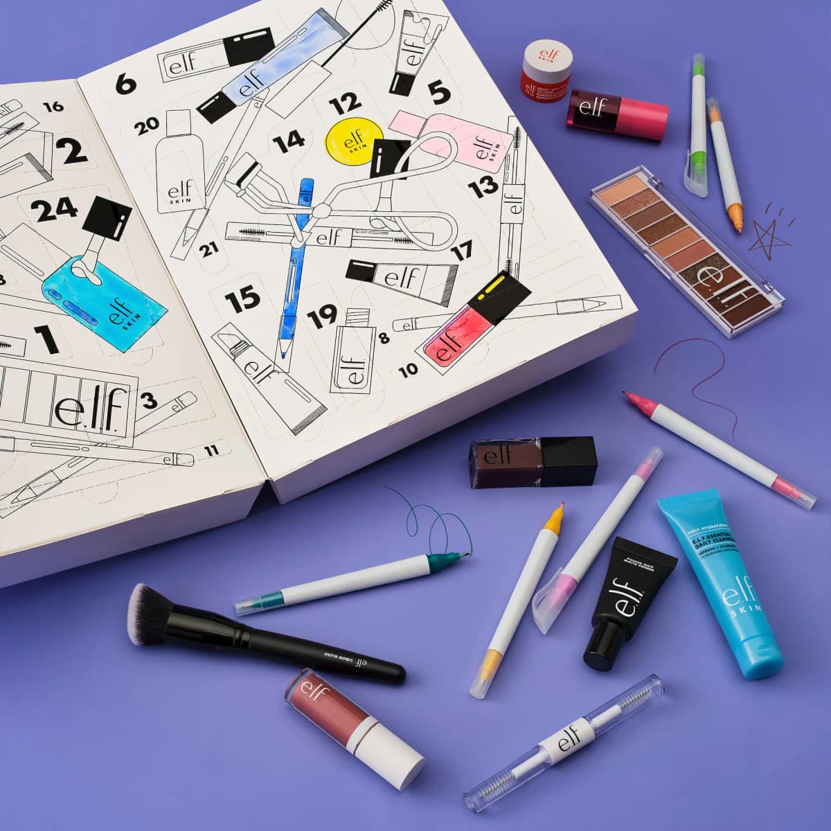 Opened calendar doors partly coloured in, with felt pens, eyeshadow palette, blush brush and cleanser on a purple backdrop