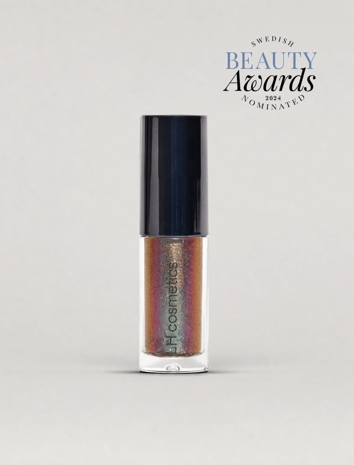 Tube holding multichrome glitter shifting from bronze to pink and green, shown with a Beauty Awards 2024 badge