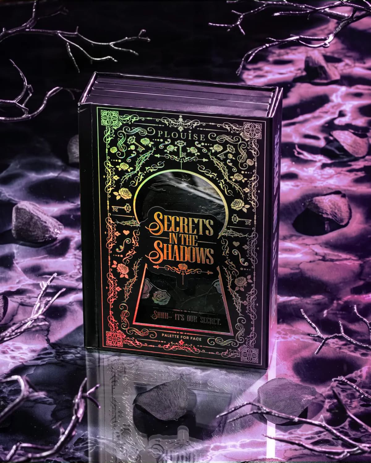 P.Louise Secrets In The Shadows palette box with iridescent foil keyhole cover, on purple marble with bare branches