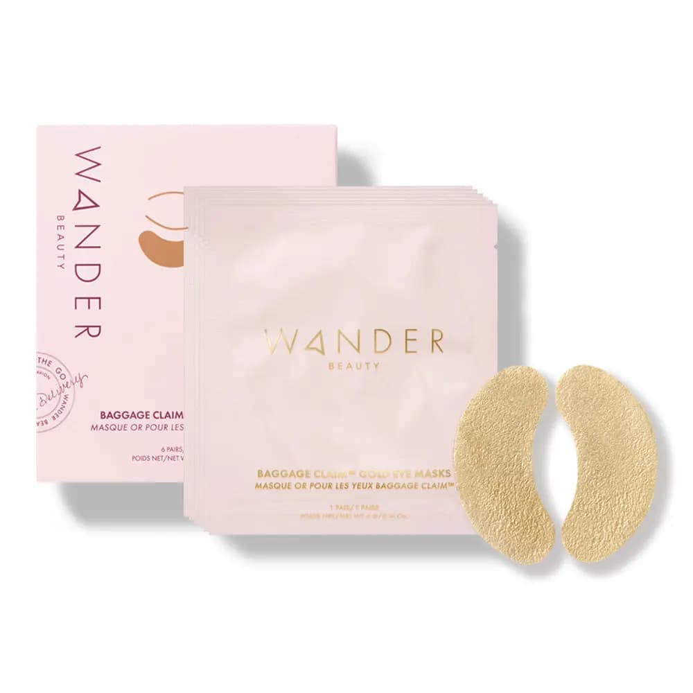 Baggage Claim Gold Eye Masks pink box and sachets with gold logo beside a pair of crinkled gold foil under-eye patches