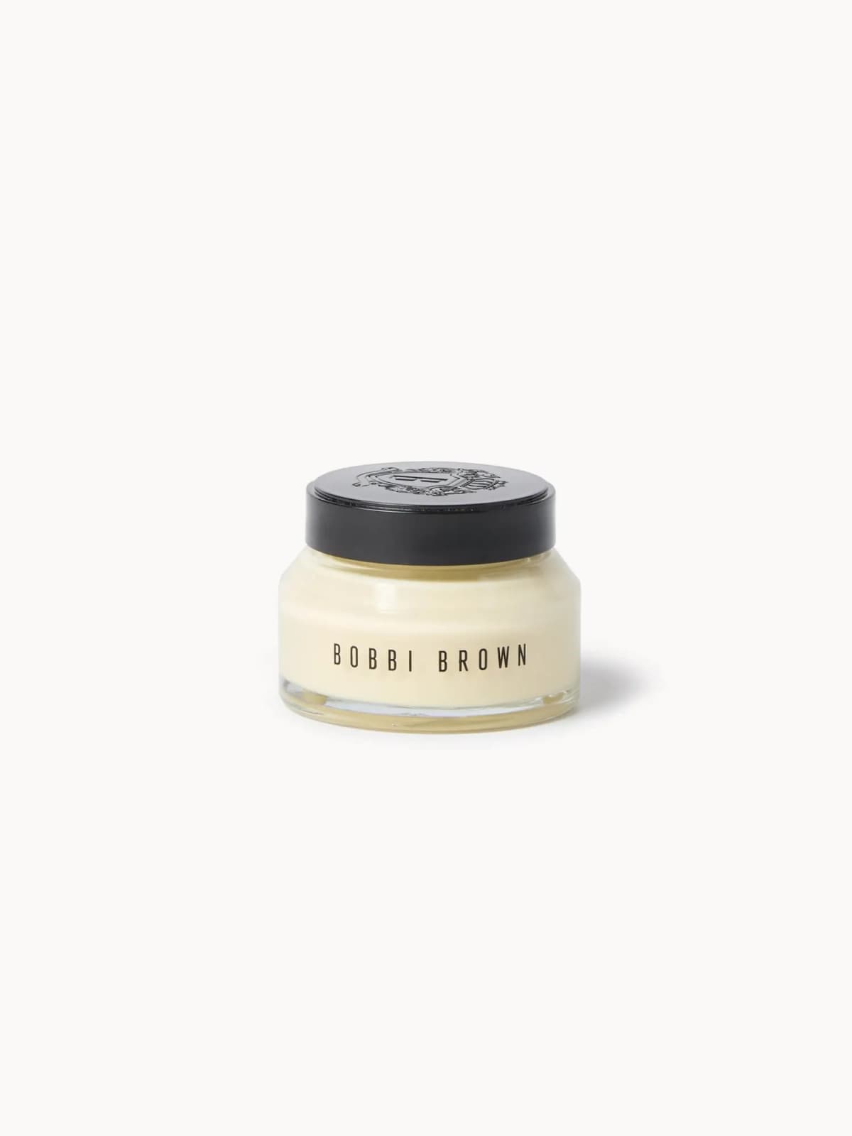 Bobbi Brown cream jar in clear glass with a black embossed lid