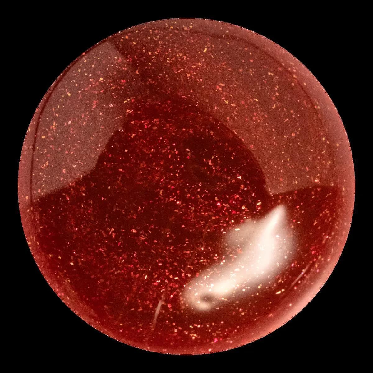 Close-up swatch of glossy red lip oil flecked with copper and gold glitter