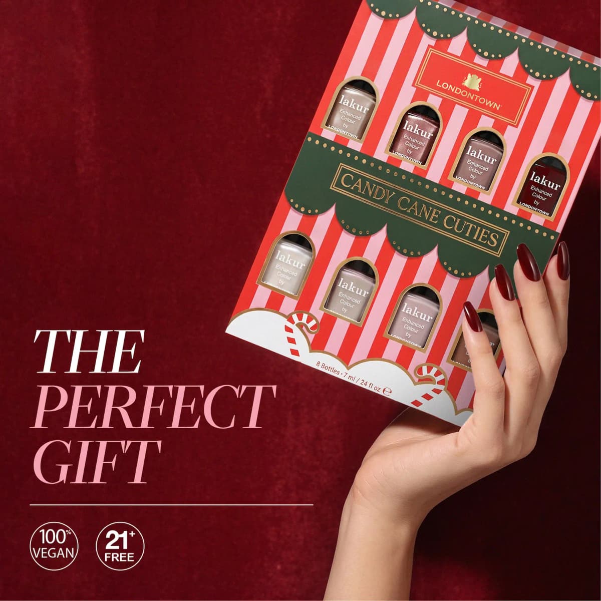 Hand with long merlot nails holds the Candy Cane Cuties box beside 'The Perfect Gift', vegan and 21+ free badges