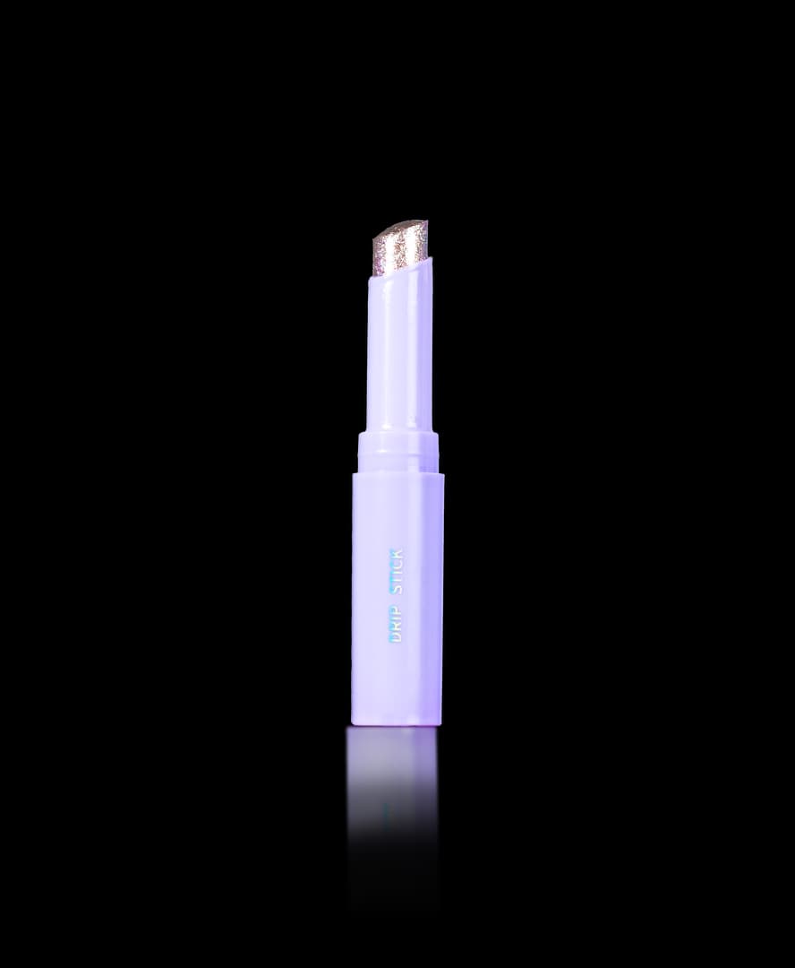 Slim lilac Drip Stick with an angled glittery rose-gold bullet tip