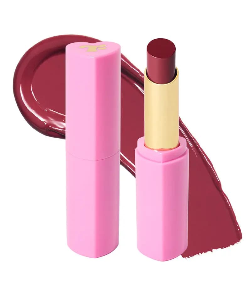 Pink heart-shaped Trixie Slix tube with gold sleeve and berry bullet beside a glossy berry swatch