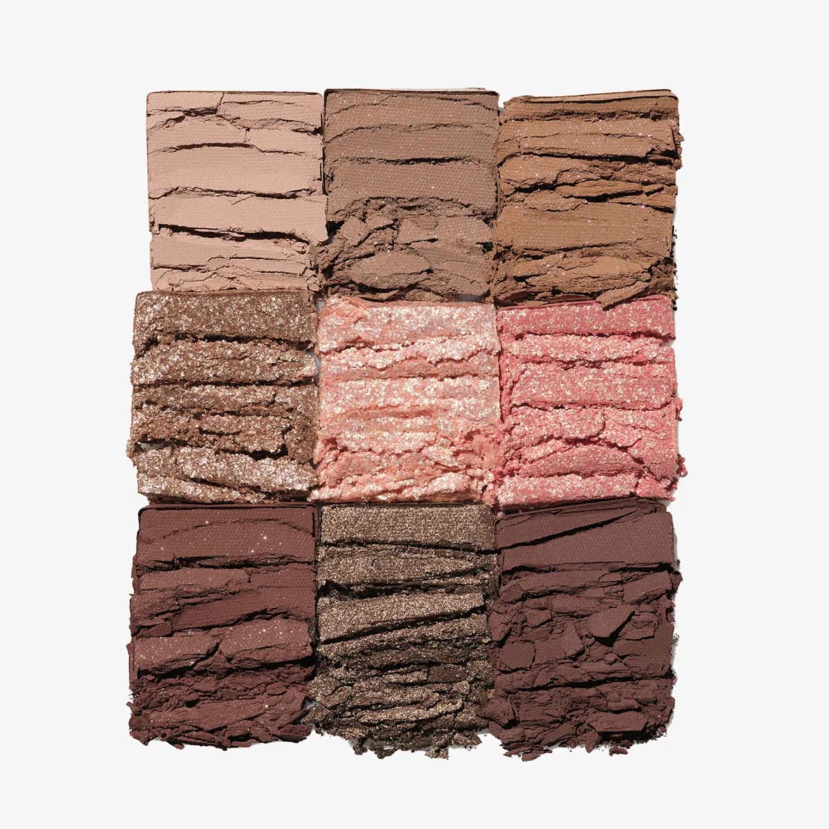 Crushed swatches of nine Spice shades: matte nudes, bronze and pink glitters, and deep chocolate browns
