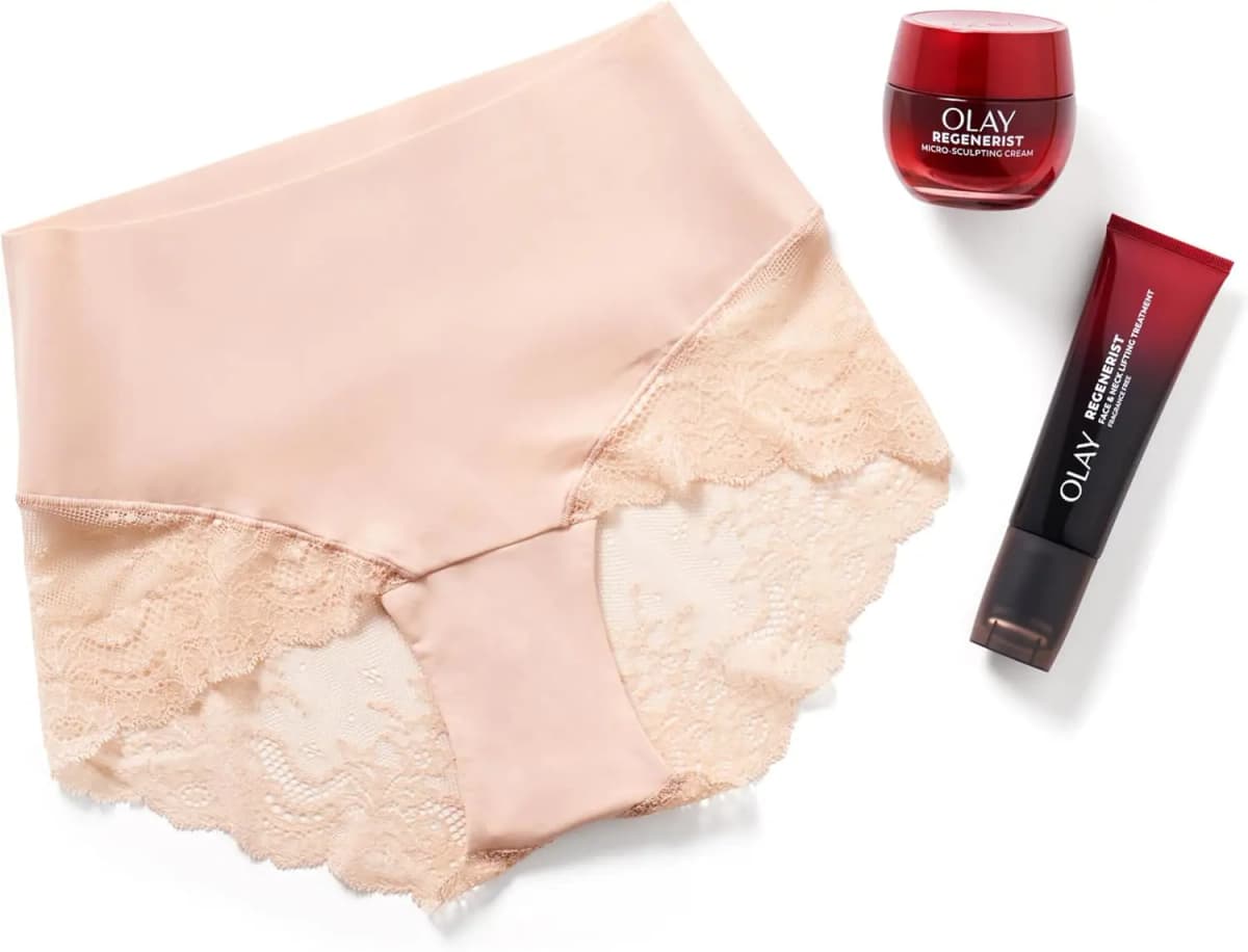 Soft Nude Spanx lace hi-hipster laid flat next to an OLAY Regenerist Micro-Sculpting Cream jar and lifting treatment tube