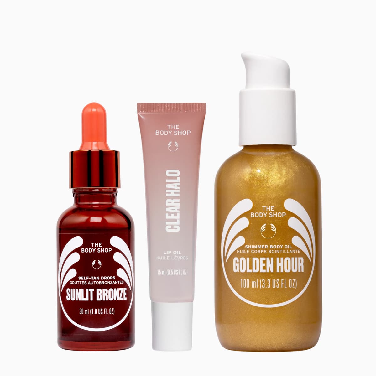 Glow & Shimmer Set trio: Sunlit Bronze tan drops, Clear Halo lip oil and Golden Hour shimmer body oil