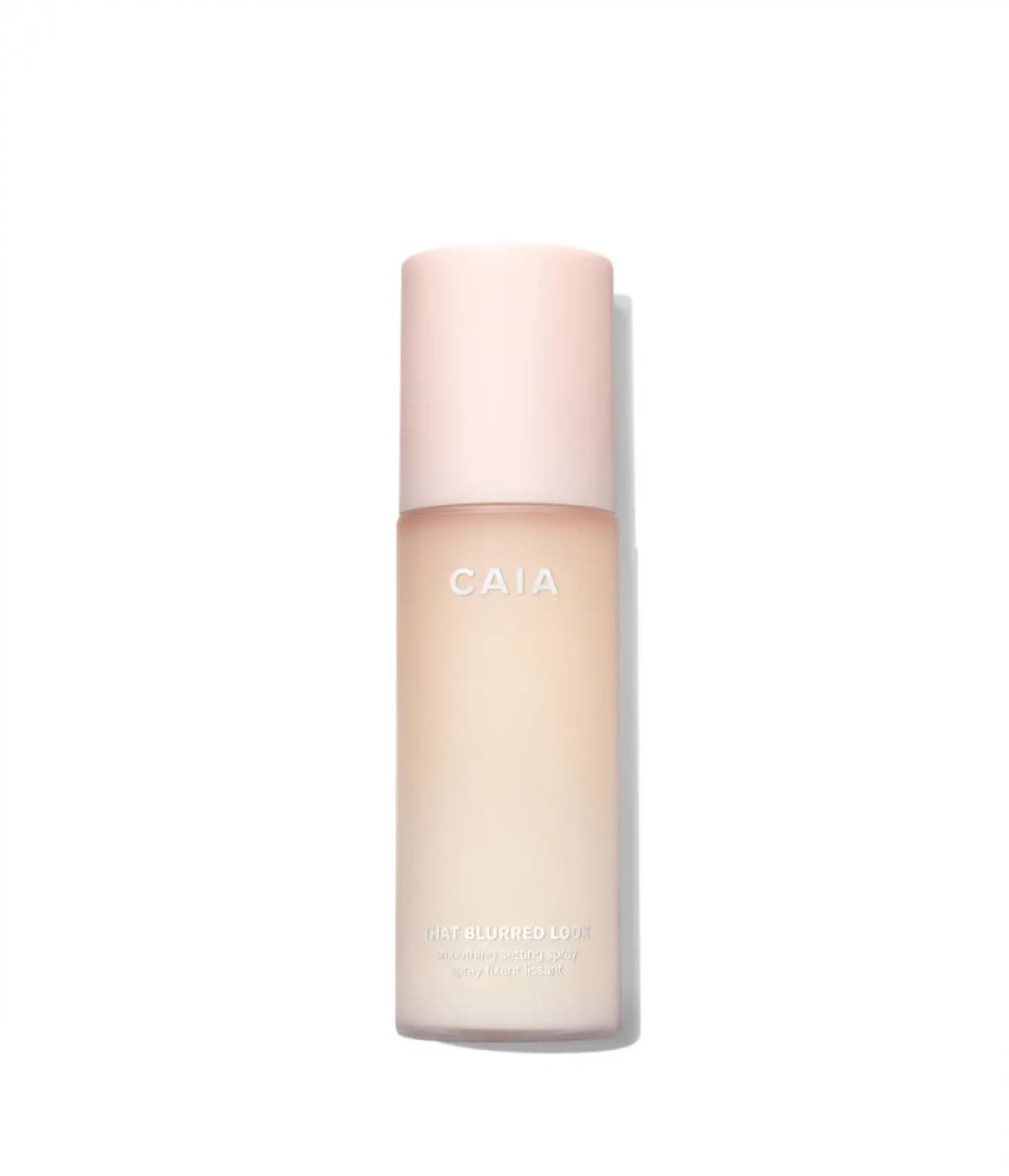 CAIA That Blurred Look Smoothing Setting Spray in a frosted peach bottle with pale pink cap on a white background