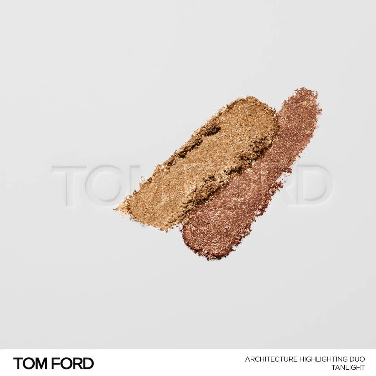 Crushed Tanlight swatches of golden bronze and shimmering rosy-copper powder on a white Tom Ford embossed surface.