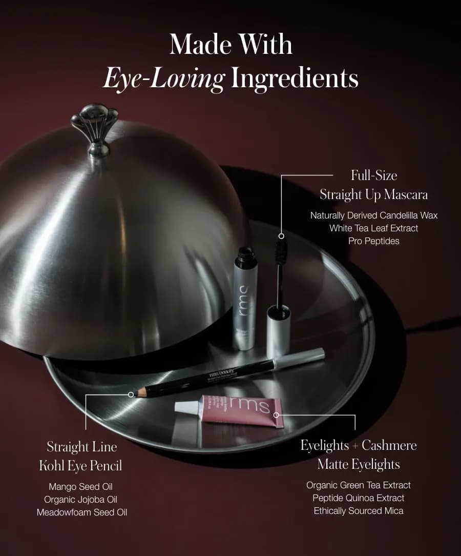 Mascara, kohl pencil and pink shadow tube on a silver tray, labelled with key ingredients for each product