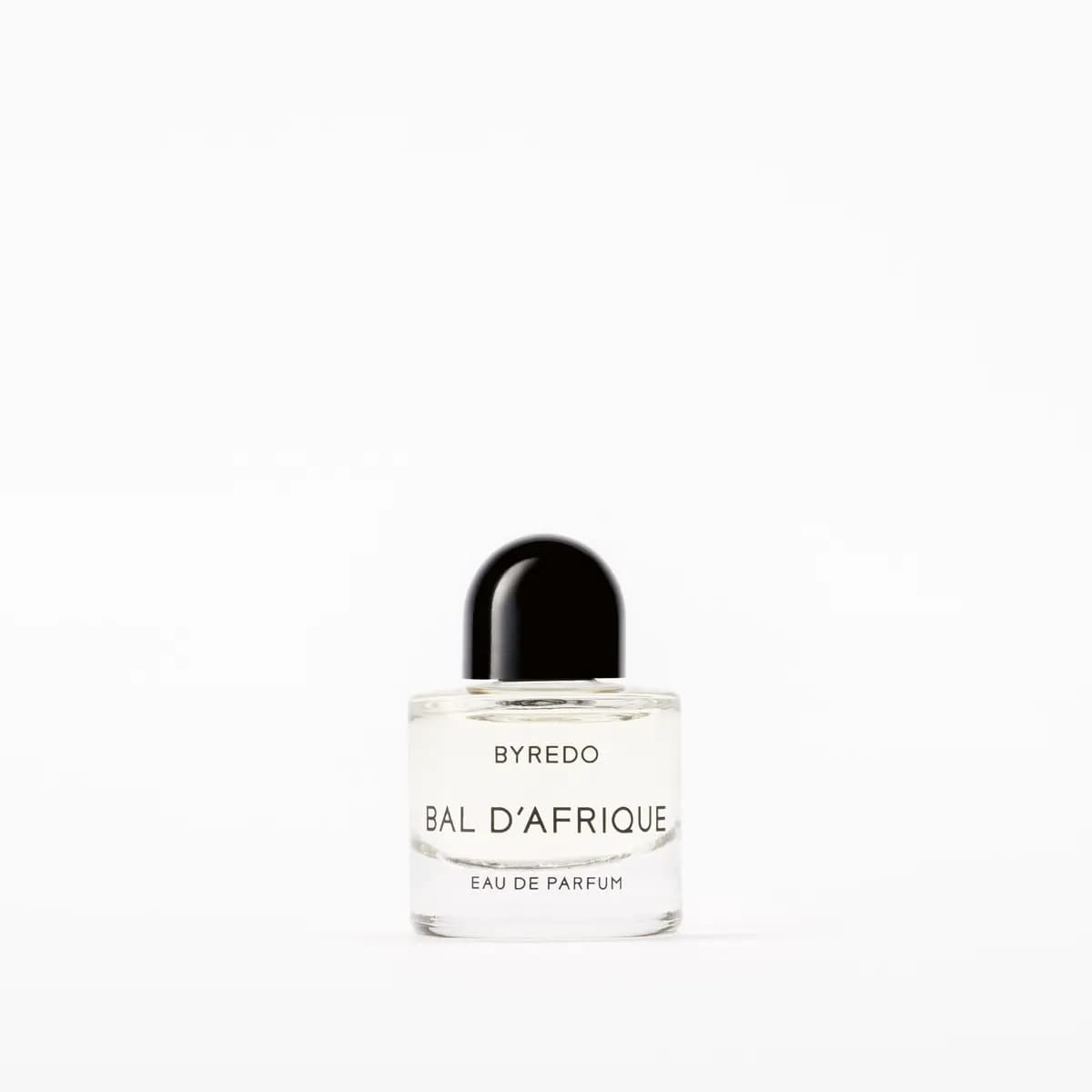 Single Bal d'Afrique Eau de Parfum mini bottle with glossy black cap on white