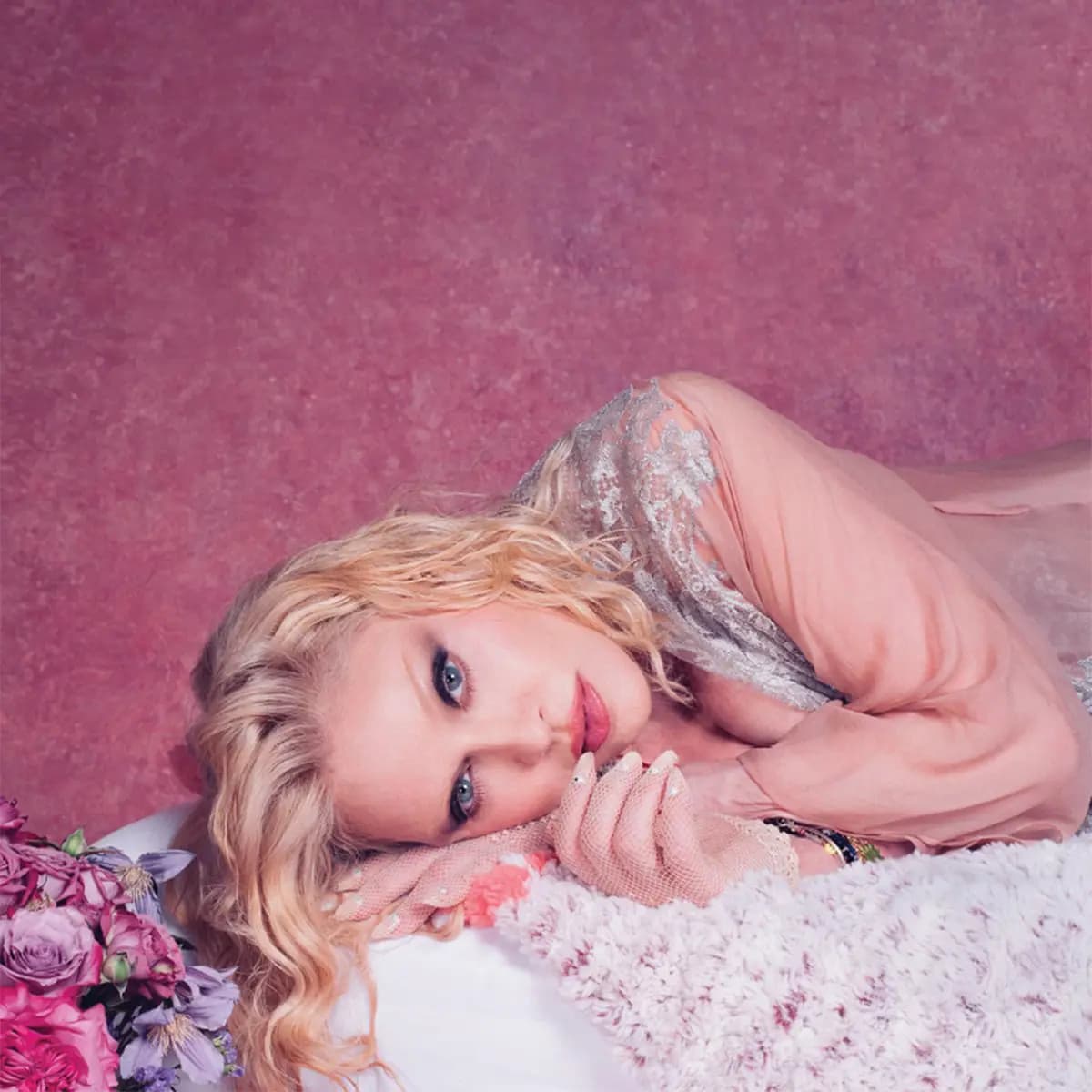 Ricardo Gomes' portrait of Madonna in pink sheer lace lying on a white throw beside roses, used on the Confessions vessel